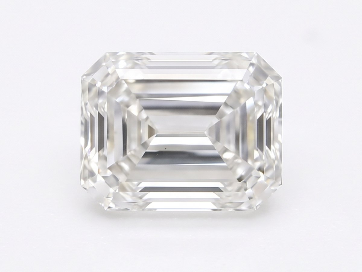 A single loose emerald-cut diamond photographed from above on a white studio ground